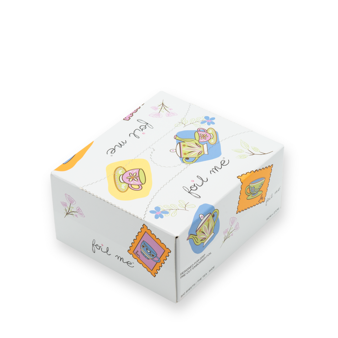 Cube-shaped product with colorful illustrations and 'foil me' text on a white background. Foil Me The Tea collection – premium fine embossed hair foils in cute design
